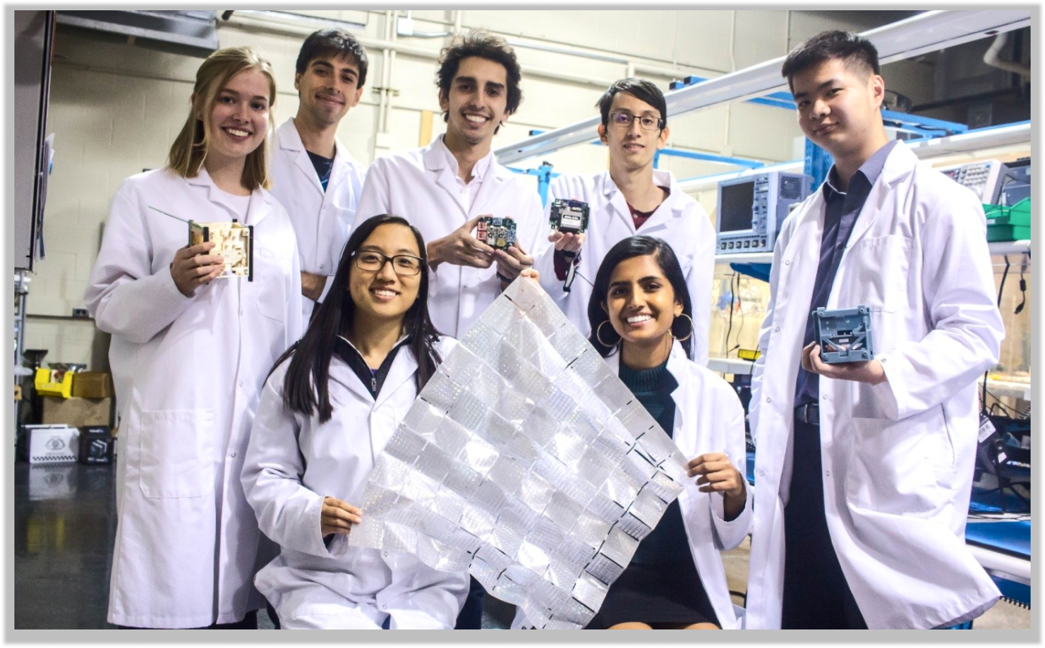 a photo of team members holding lightsail components 